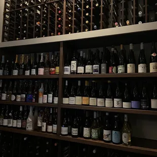 rows of wine bottles in a wine cellar