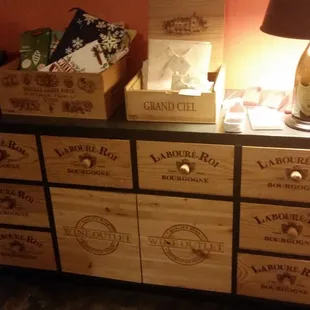 a dresser with wine crates and a lamp