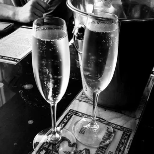 two glasses of wine on a bar