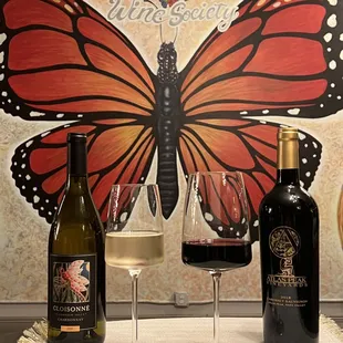 a glass of wine and two bottles of wine