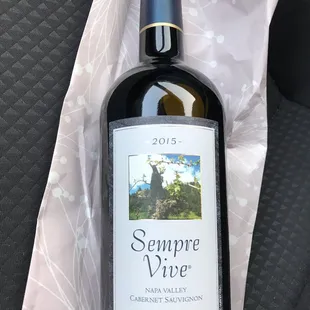 a bottle of wine in the back seat of a car