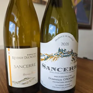 two bottles of wine on a table