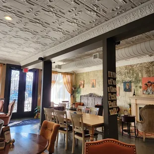 a dining room with a fireplace and chairs