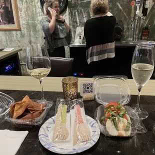 a table with food and wine glasses