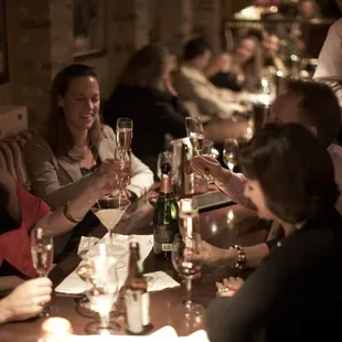 a group of people toasting wine glasses