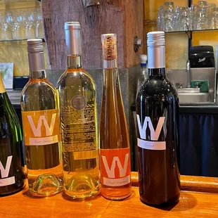 three bottles of wine on a bar