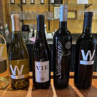 a selection of wines on a bar