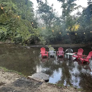 red chairs and a table in the water