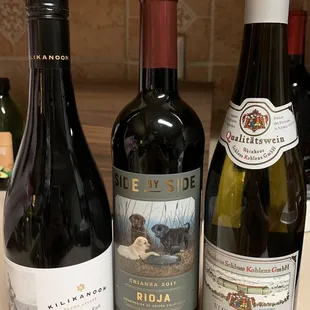 three bottles of wine on a countertop