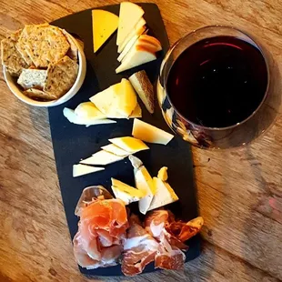 a glass of red wine and cheese