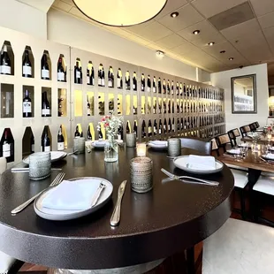 Interior dining with a huge wine wall in the background.