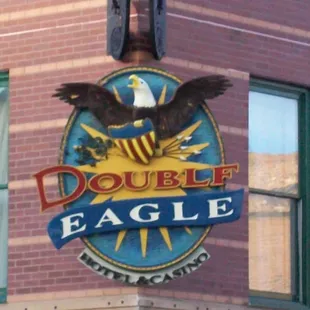 a double eagle sign on a brick building