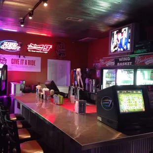 a view of a bar with neon signs
