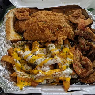 Undercooked fried catfish, fried shrimp, and cheese ranch fries
