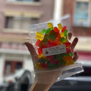 a person holding a bag of gummy bears