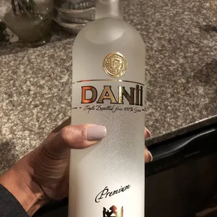 a hand holding a bottle of vodka