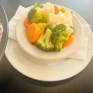 a plate of broccoli, cauliflower and carrots