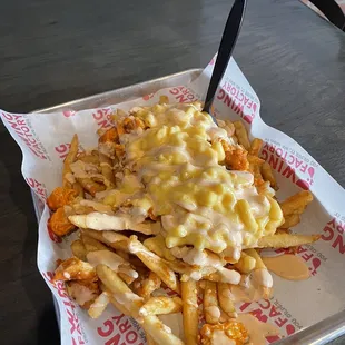 chicken and cheese fries in a container