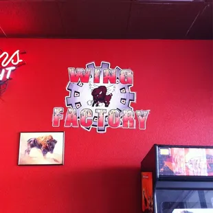 a red wall with a red neon sign