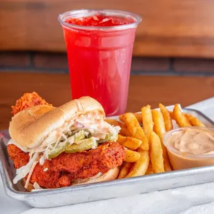 a chicken sandwich with fries and a drink