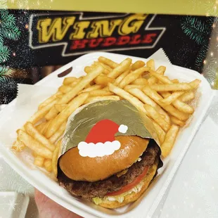 a burger and french fries in a styrofoam container