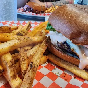Side view of the burger with Cajun fries.