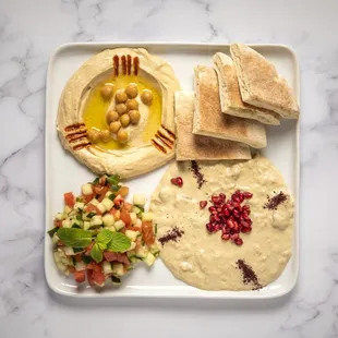 a plate of hummus and pita bread