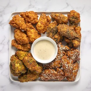 a plate of fried food with dipping sauce
