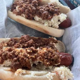 Two hot dogs with chili, slaw, and...mustard packets