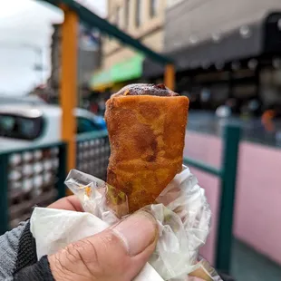 a hand holding a pastry