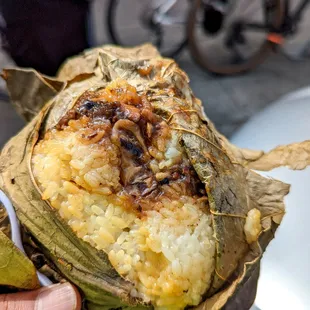 a person holding a piece of food
