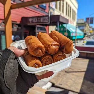 a person holding a tray of food