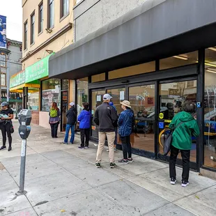 a line of people waiting outside