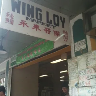 a group of people standing in front of a store