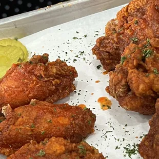 a tray of fried chicken and a pickle