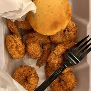 fried doughnuts in a plastic container with a fork