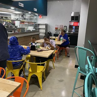 people sitting at tables in a restaurant