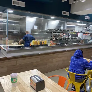 two people sitting at a table in a cafeteria
