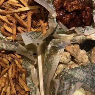 a tray of chicken wings and french fries