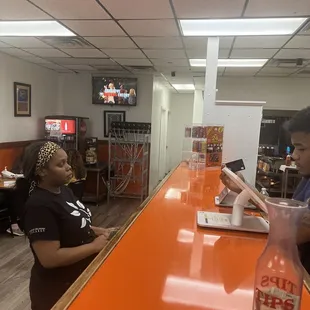 two people sitting at a bar