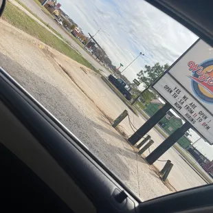 a view of a sign from inside a car