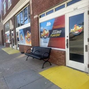 a bench on a sidewalk in front of a building