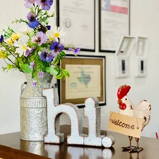 a vase of flowers and a sign on a table