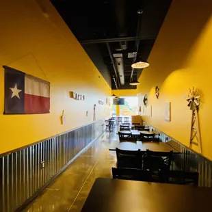 a long hallway with tables and chairs