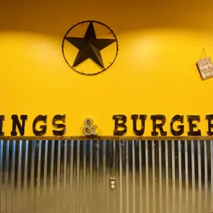 the sign for wings and burgers