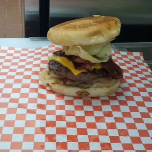 Regular Cheese Burger with bacon and grilled Onions.