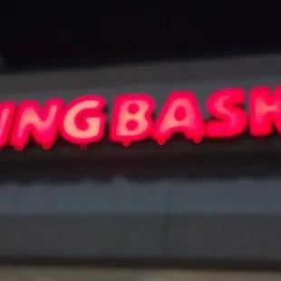 a neon sign on the side of a building