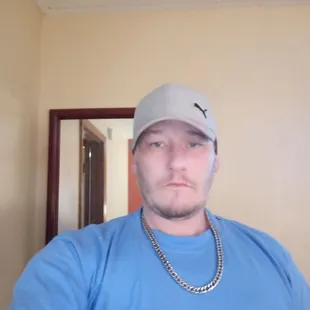 a man in a blue shirt and cap