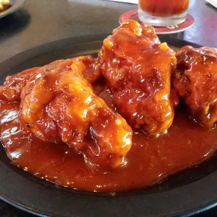 a plate of chicken wings covered in sauce