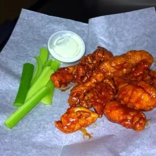 a piece of celery and a bowl of ranch dressing